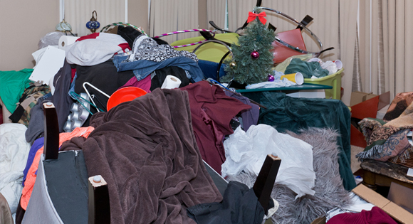 piles of clothes and junk taking up entire room