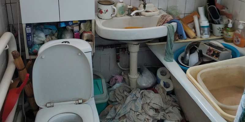 Bathroom full of piled up household junk