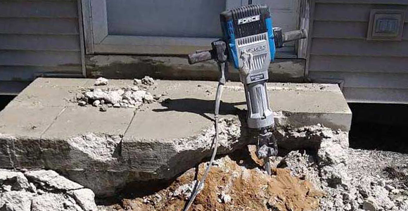 Jackhammer removing a concrete slab