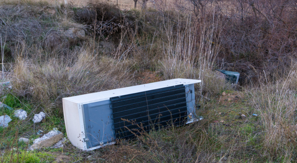 abandoned refrigerator in field