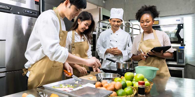 diverse group of people taking culinary class