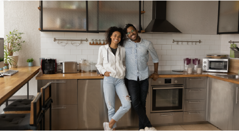 couple standing in decluttered and organized kitchen