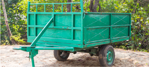 trailer dumpster sitting on sand driveway