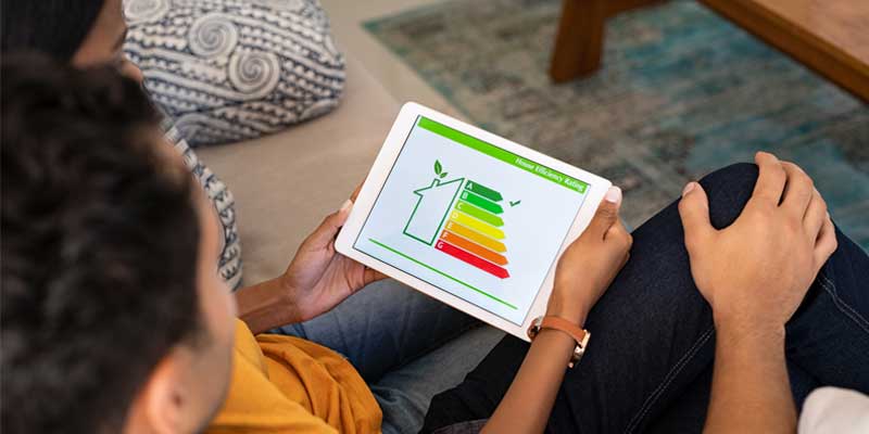 Couple looking at tablet checking house energy efficiency