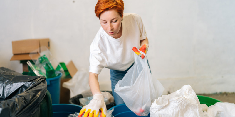 woman sorting through household junk