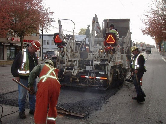 Paving the street with recycled plastic mixed in asphalt