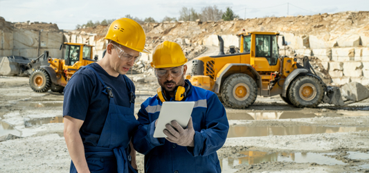 Construction workers looking at blueprint at worksite 