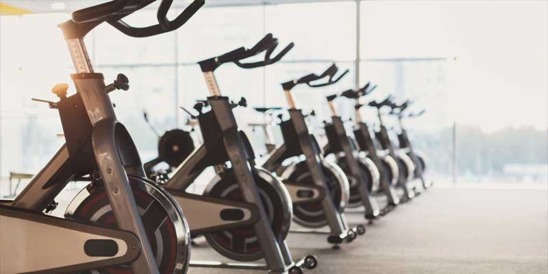 row of exercise bikes in gym