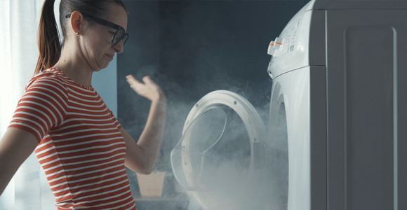 woman opening smoking dryer