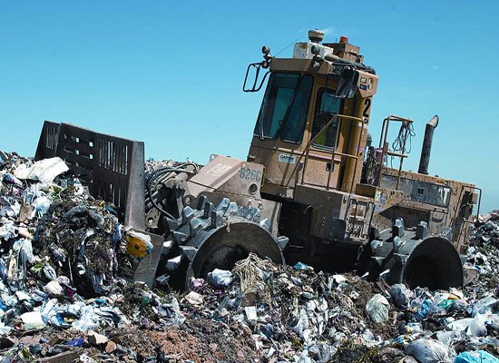 Landfill trash compactor machine
