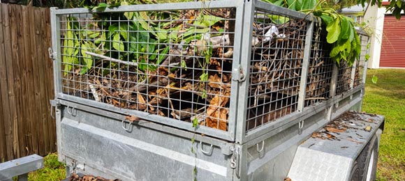 trailer dumpster full of yard waste