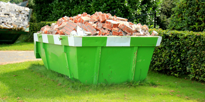 dumpster overloaded with bricks