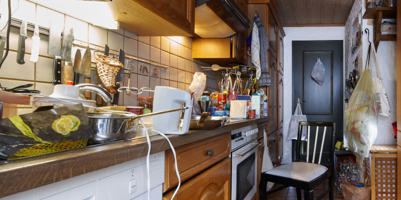 junk-riddled apartment kitchen