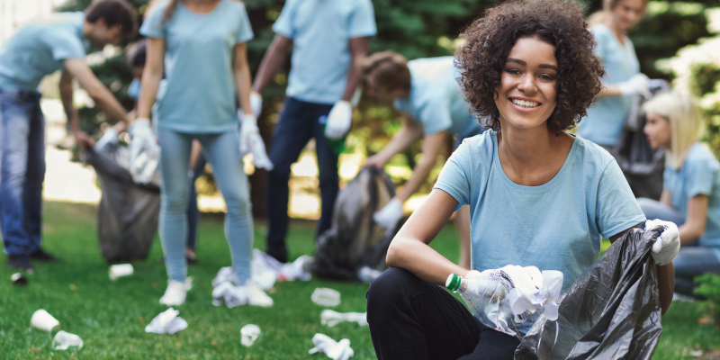 woman smiling at camera during cleanup event