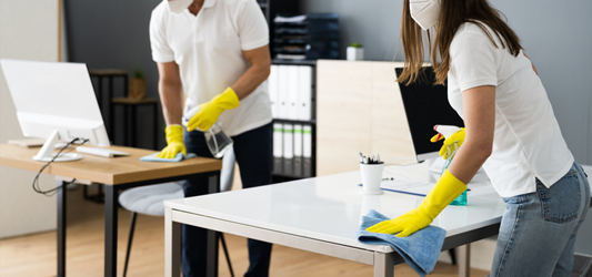 Two people cleaning a home wearing protective gloves and mask