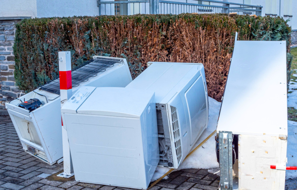 multiple white appliances placed outside home