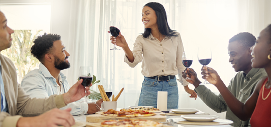 Friends saying a toast at a dinner table