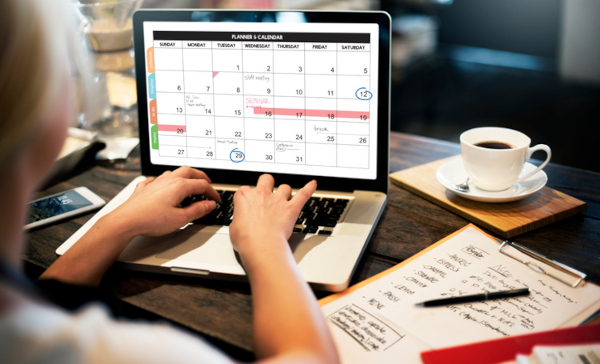 person looking at calendar on laptop