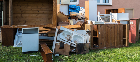 kitchen fixtures and debris from interior demolition placed on residential lawn