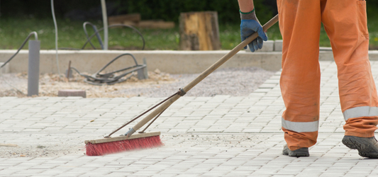 Junk removal worker sweeping up construction site