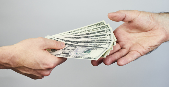 handing worker a cash tip