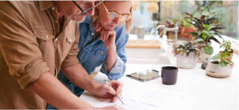 mature couple going over documents in kitchen