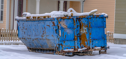 Roll-off dumpster on snow-covered road