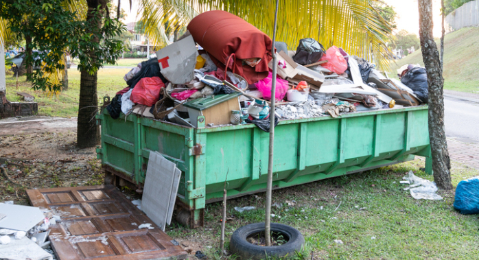 Roll-off dumpster overflowing with household waste