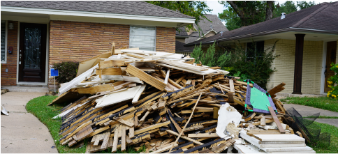 pile of debris from a hurricane sitting in front yard