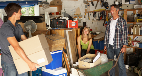 family cleaning out cluttered garage
