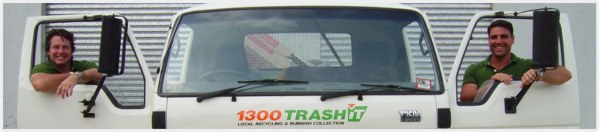 two men looking through junk removal truck doors