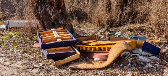 broken furniture and abandoned junk in yard