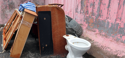 Pile of broken furniture and toilet at road