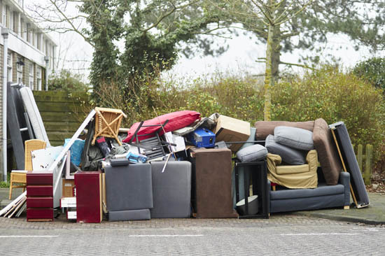 pile of furniture and other junk at the curb