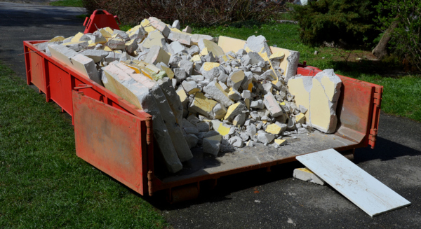 Dumpster loaded with concrete debris