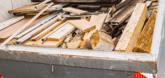 wood debris inside a dumpster