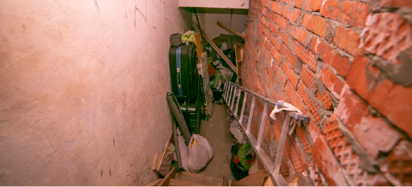 looking down stairs at junk piled in basement