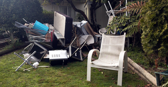 Pile of household junk and broken furniture in yard