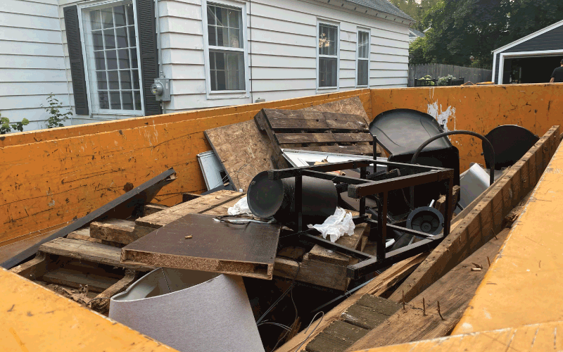 dumpster with household junk