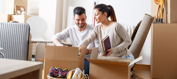 Couple organizing and boxing belongings