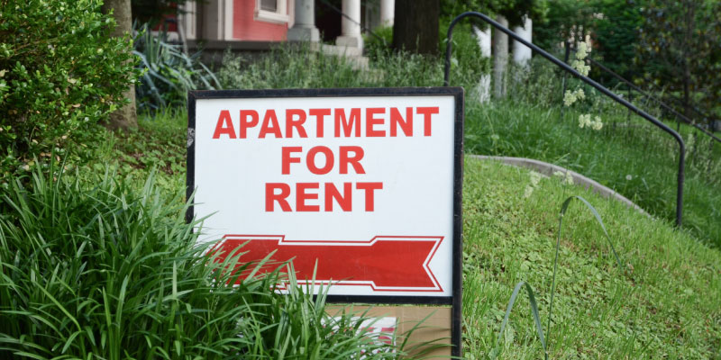 apartment for rent sign in front of duplex