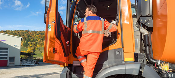 Dump truck driver getting into vehicle