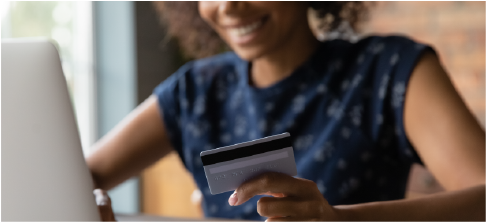 smiling woman making online payment with credit card