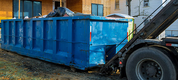 dumpster rental being picked up