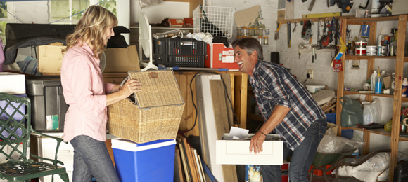 couple cleaning out a cluttered garage