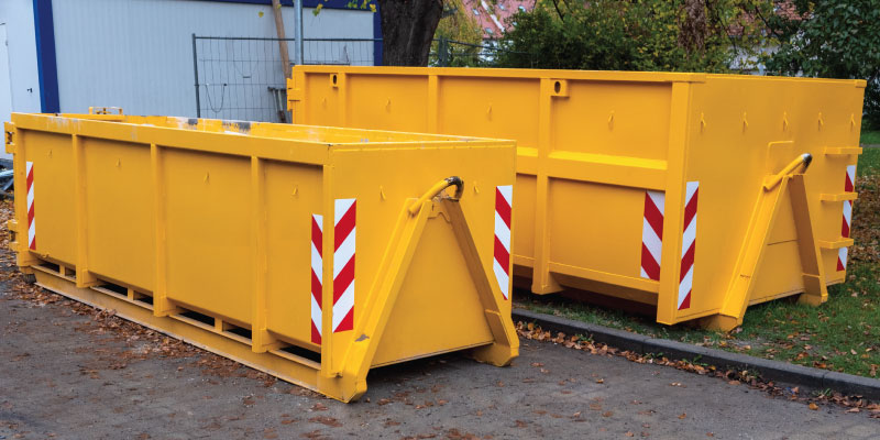yellow dumpsters in parking lot