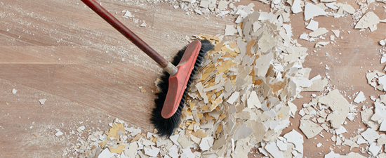 sweeping up renovation debris indoors