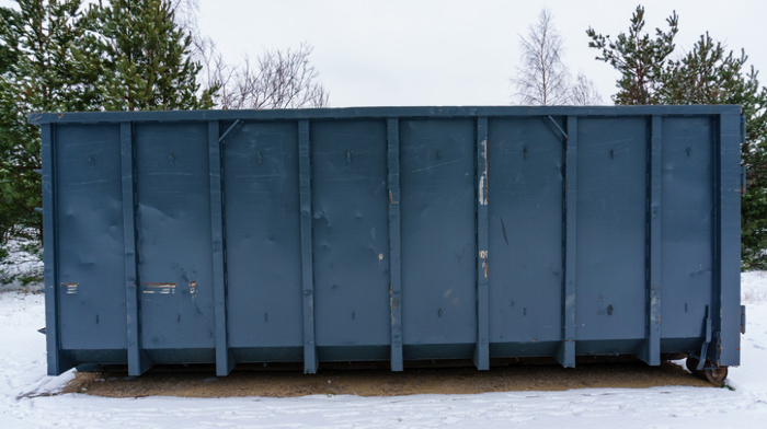 roll-off dumpster on snowy pavement