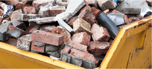 bricks and heavy debris in dumpster