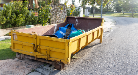 yellow roll off trash dumpster parked in the street